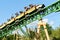 Man saluting, while traveling at high speed in faster Cheetah Hunter Rollercoaster at Bush Gard