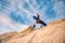 Man sand boarder standing on top with snowboard before extreme downhill