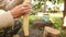 A man is sanding a wooden handle for an ax.