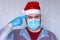 man in a Santa Claus costume and a medical mask.  Bad Santa represents a bad year. 