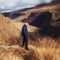 A man in a Santa Claus hat. Against the backdrop of a magnificent backyard. A huge gorge and beautiful clouds on the