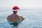 Man in Santa Claus hat on the beach, Christmas holidays. Relax in tropical countries in the winter, New Year& x27;s weekend.