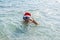 Man in a Santa Claus hat and diving mask, Christmas background with copy space. New Year holidays