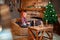 Man in Santa Claus hat in new year decor of house