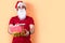 Man with Santa Claus hat and white beard, offering presents; orange background with a copy space