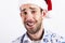 Man in santa hat over white background. Smilling at camera.