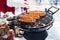 Man in Santa outfit grilling sausages