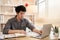 Man sat typing away on a laptop in his office with a determined look on his face