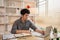 Man sat typing away on a laptop in his office with a determined look on his face