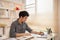 Man sat typing away on a laptop in his office with a determined look on his face