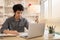 Man sat typing away on a laptop in his office with a determined look on his face