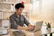 Man sat typing away on a laptop in his office with a determined look on his face