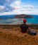 Man savoring the breathtaking sunrise over the crystal blue waters of Balos lagoon