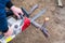 A man is sawing a fallen tree with an electric chain saw