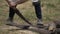 Man sawing plank of wood outside with a handsaw. Male man hand with a saw