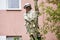 A man is sawing a tree upstairs. The ropes supporting a person are sawing a tree. A sophisticated rope system to support a person