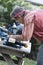 Man Sawing Wood with Sliding Compound Miter Saw