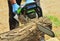 A man saws a log with a big chainsaw