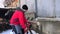 A man saws logs using an electric saw. Outdoor shot on a winter day.