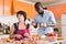 Man scolding woman cooking dinner