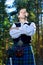 Man in scottish costume with sword and pipe