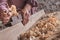 Man scraping curled wood scraps with hand plane tool