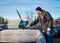 Man scraping front windshield