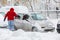 Man scraping frozen snow from the car windows