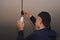 a man screws in a light bulb. installation of the LED lamp