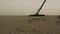 A man by the sea with a metal detector examines the sand.treasure hunter