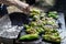 Man seasoning green peppers grilled on the barbecue. Barbecue time in the nature