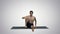 Man in Seated Marichyasana yoga pose stretching leg and spine exercise on gradient background.