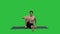 Man in Seated Marichyasana yoga pose stretching leg and spine exercise on a Green Screen, Chroma Key.