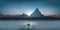 A man, seated on a pontoon, watches a sunset over a lake in front of a mountain landscape.