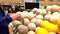 Man selecting cantaloupe in grocery store