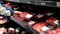 Man selecting raw beef in grocery store