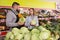 Man seller is helping to buy cabbage in grocery shop