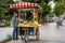 Man selling grilled corn from cart on the summer Istanbul street. Turkish street food business