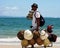 Man selling hats walking on the paradisiacal beaches of Maceio, Brazil.