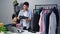 Man selling shoes and clothes online by smartphone live streaming, business online e-commerce at home