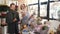 Man and senior florist consultant choosing bouquet at flowers shop