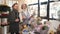 Man and senior florist consultant choosing bouquet at flowers shop