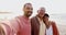 Man, senior parents and beach selfie with hug, care and bonding in summer sunshine for vacation in Mexico. Father