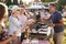 Man Serving On Barbeque Stall At Summer Garden Fete