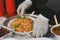 Man serving fried rice in paper plate