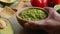 Man serving guacamole bowl