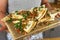 Man serving Mexican chicken quesadillas on wooden board