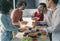 man serving pasta to his friends during lunch in dining room