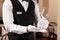 Man setting table in restaurant, closeup. Professional butler courses