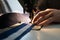 A man sews yacht accessories on a sewing machine. Close-up